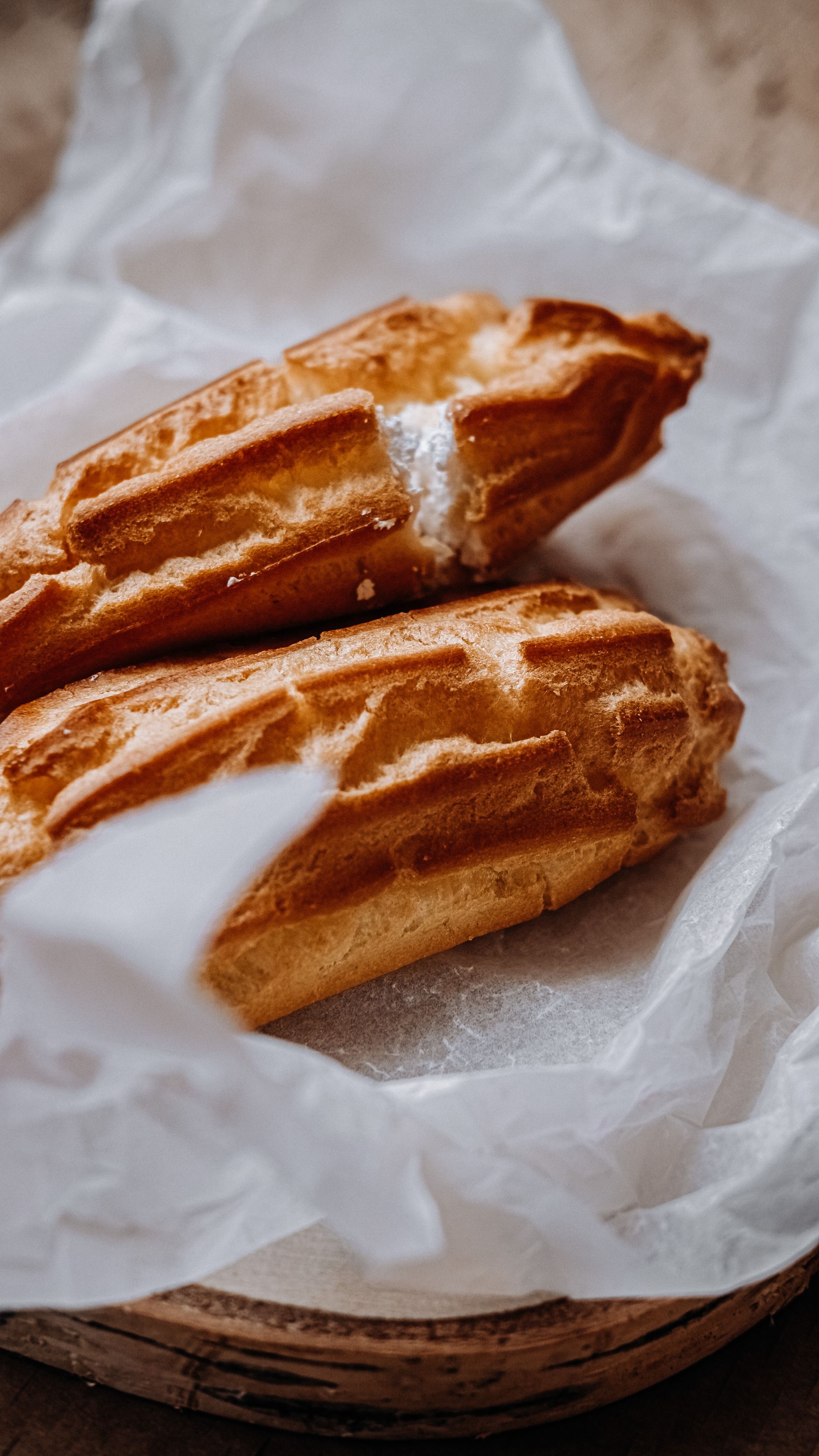 Éclair shells fresh from the oven, showing the ridged piping and split sides of well-made pâte à choux