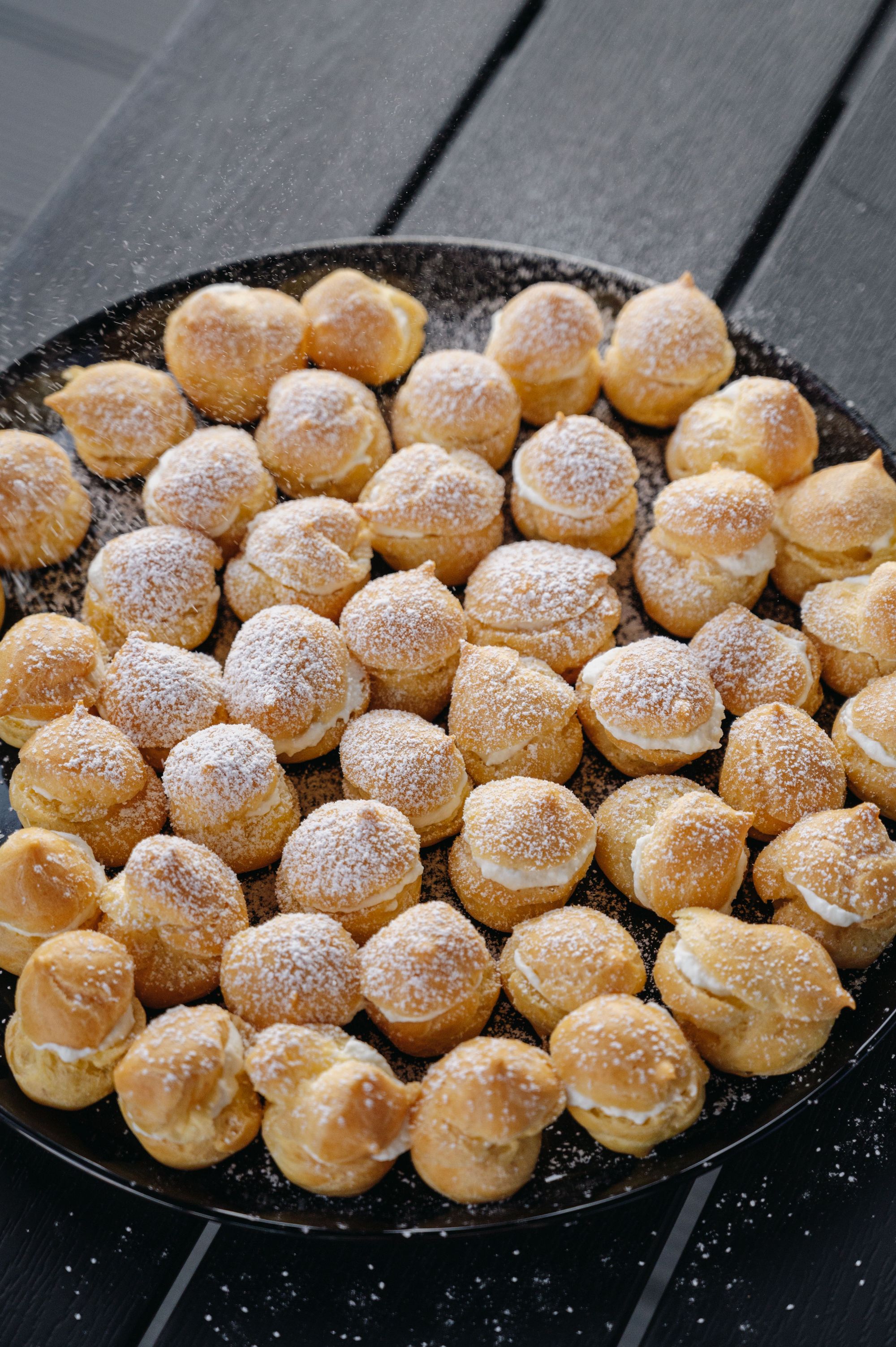 Trays of choux buns cooling after the bake